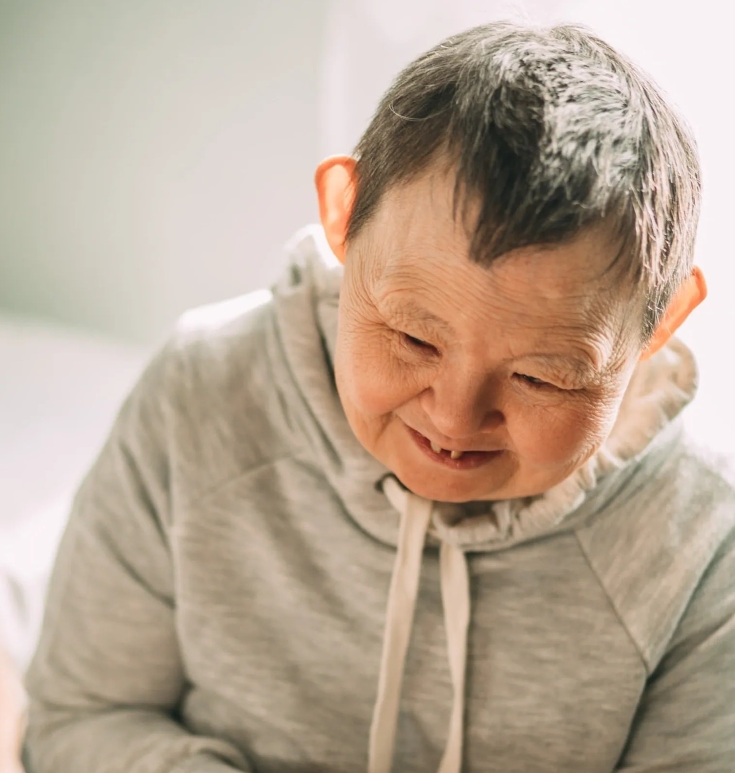 Compassionate caregiver with elderly client at Uplift
